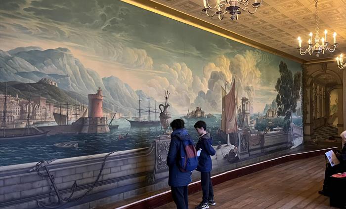 Clients looking at mural in Plas Newydd